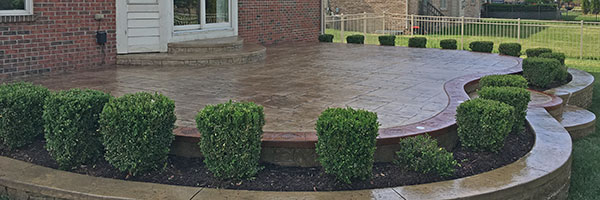 sealed stamped concrete patio and retaining wall